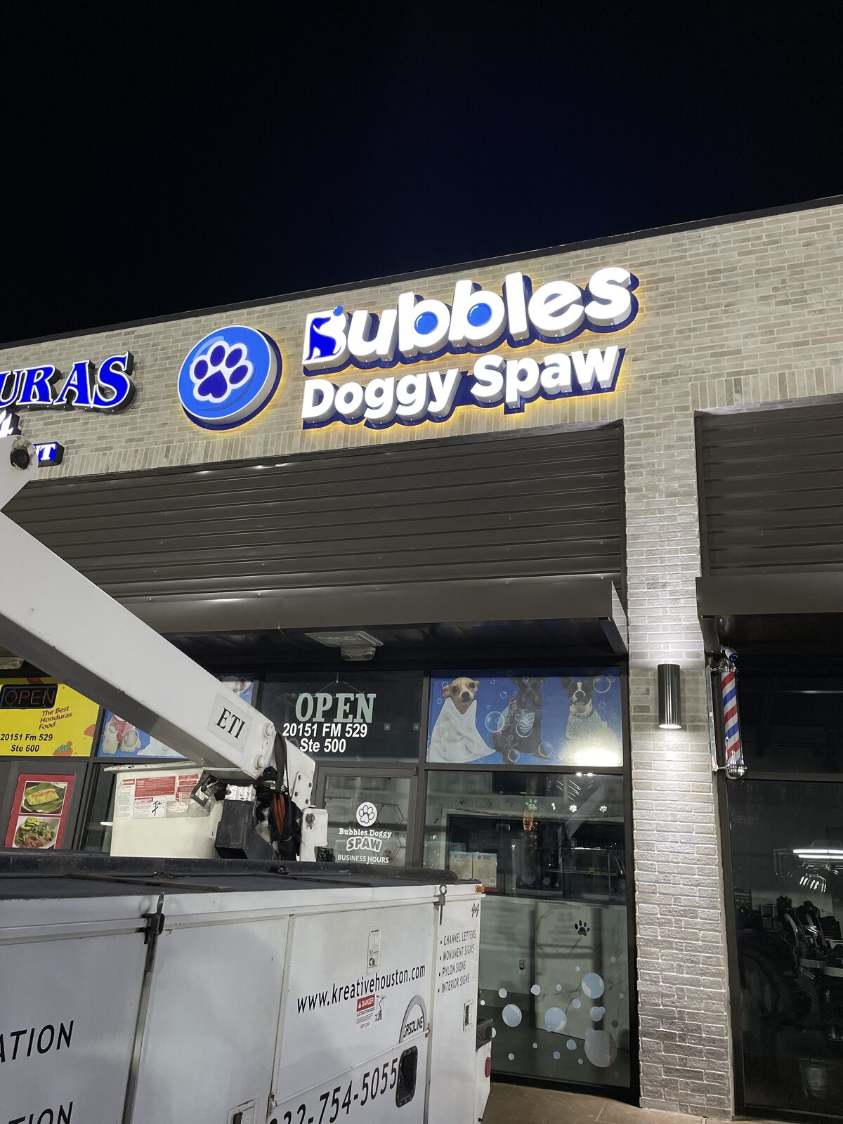 Bubbles Doggy Spaw illuminated channel letter sign at night, Houston, TX