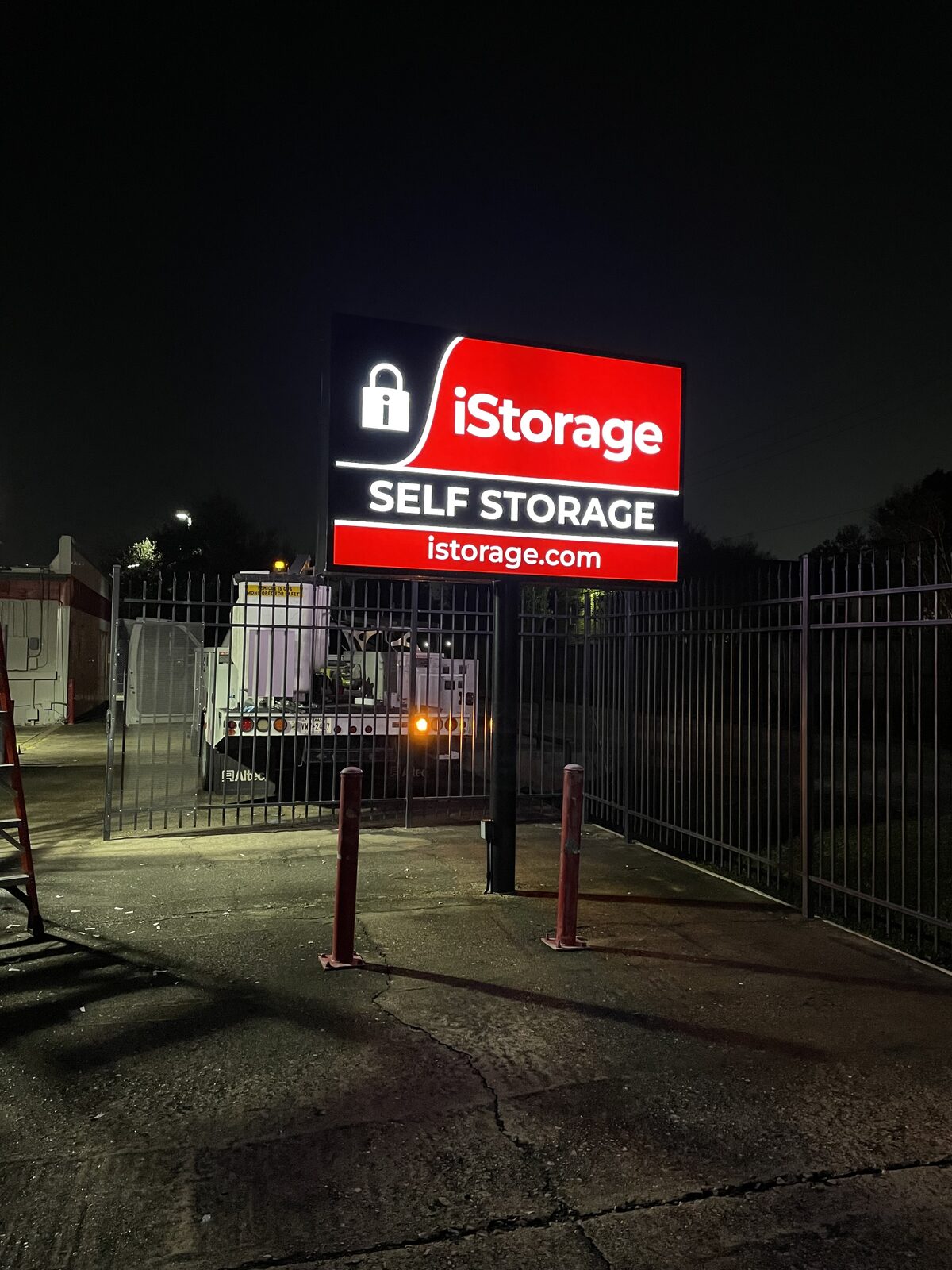 iStorage illuminated monument sign at night, Houston, TX